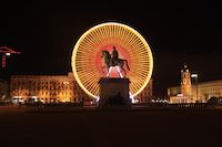 Statue avec une grande roue derrière sur la place Bellecour à Lyon statue, place, cheval, grande roue